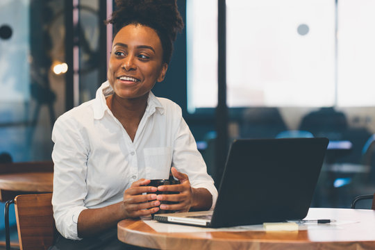 Smiling Businesswoman Having Coffee In Office