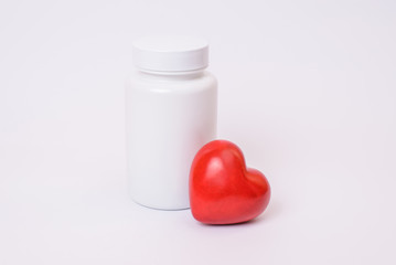 Cure vial pattern template remedy copyspace copy-space clinical concept. Close up photo of big white without label place for text with small little red shiny heart isolated on clear background