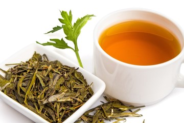 Cup of Green Tea with Dried Leaves Tea in Bowl