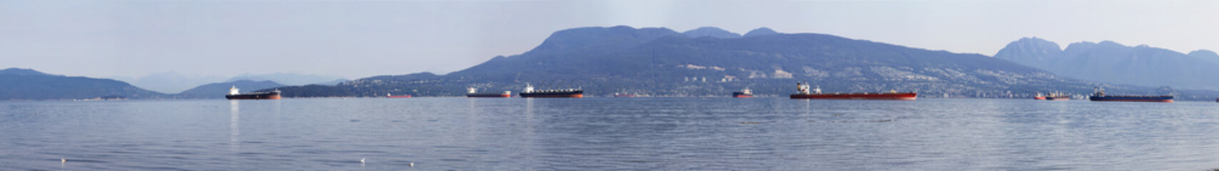 View of the Burrard Inlet looking towards English Bay, Vancouver, British Columbia, Canada; North shore mountains visible from the Spanish Banks Beach Park
