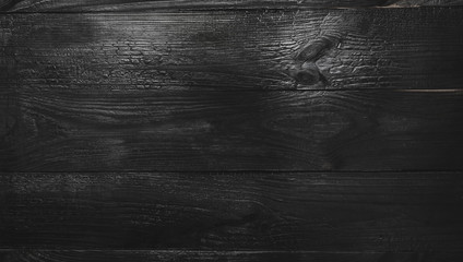 Upper, top view of a black wooden blackboard background in old, rustic style