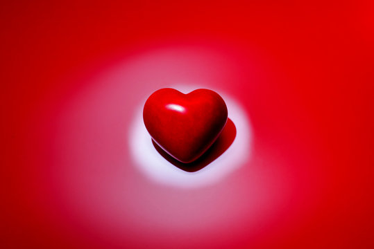 Top above overhead view close up photo of beautiful cute lovely sweet tender little bright vivid red 3d heart with reflected light isolated on soft red and white background copy-space cutout