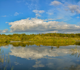 Sunny autumn day on the shore of an artificial lake.