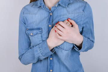 First symptoms of problems with heart concept. Cropped close up photo of sad unhappy upset lady...