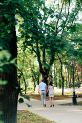 Fototapeta na wymiar young loving couple walking in the park outdoors