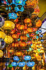 Naklejka premium ISTANBUL, TURKEY - August 29, 2018: Woman tourist walking among countless shops in Grand Bazaar market in Istanbul. Shopping and travel in Turkey concept
