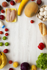 Shopping groceries concept. Frame of various healthy food on white wooden table. Cooking food background. Fresh fruits, vegetables, greens, meat, milk. Top view, overhead, from above.