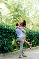 Naklejka na ściany i meble young loving couple walking in the park outdoors