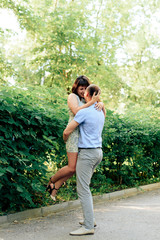 Naklejka premium young loving couple walking in the park outdoors