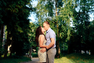 young loving couple walking in the park outdoors