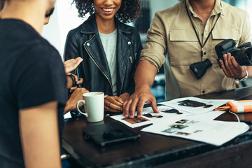 Team of photographers reviewing photos after photo shoot