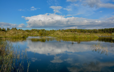 Sunny autumn day on the shore of an artificial lake.