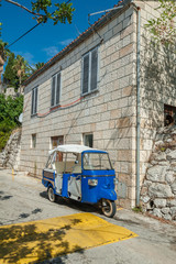 Fototapeta na wymiar Croatia, Hvar. Blue motorbike taxi. It is sometimes the only way to drive in very narrow alleys. No car allowed in to old town.