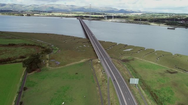 Aerial footage of traffic crossing Clackmannanshire Bridge over the River Forth.