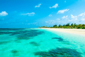 Beautiful sandy beach with sunbeds and umbrellas in Indian ocean, Maldives island