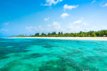Beautiful sandy beach with sunbeds and umbrellas in Indian ocean, Maldives island
