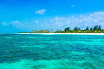 Beautiful sandy beach with sunbeds and umbrellas in Indian ocean, Maldives island