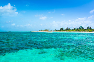 Beautiful sandy beach with sunbeds and umbrellas in Indian ocean, Maldives island