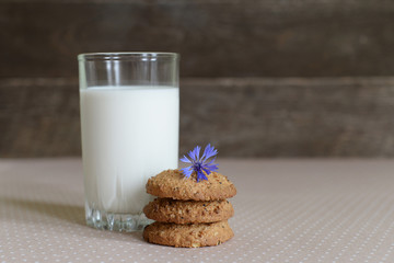 a glass of milk and oatmeal cookies, rustic style