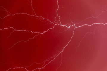 Lightning bolt in a red sky.