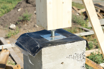 Adjustable wooden post support. Construction of a wooden house.