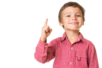 young adorable boy smiling and pointing finger upwards, isolated on white background