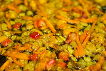 cooking a roast for soup of onions, carrots, paprika, tomatoes, herbs and spices in sunflower oil in a frying pan