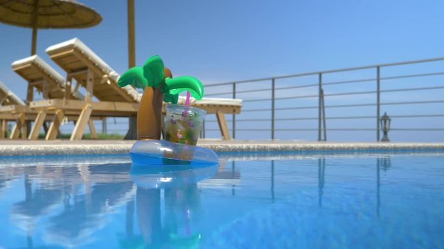 Inflatable Drink Holder With Plastic Cup Floating In The Pool