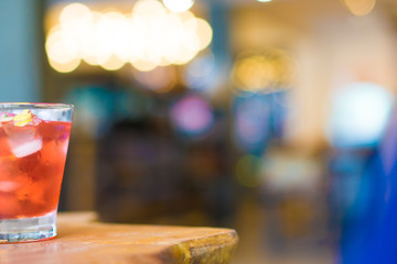 Tea of rosewater on wooden table with copy space.  Cafe lighting bokeh background concept.