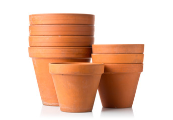 Group of empty, stacked, used terracotta planting pots over white