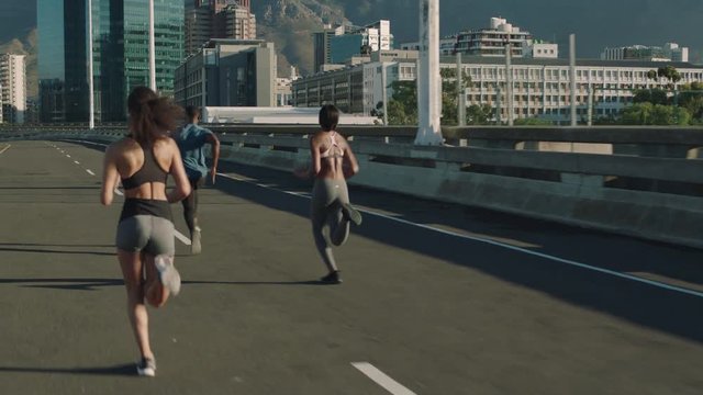 african american man running overtaking runners in competitive urban city race competition on early morning road sprinting fast at sunrise