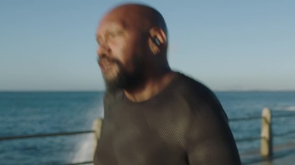overweight african american man running intense workout jogging challenge male exercising early morning seaside bald black athlete close up