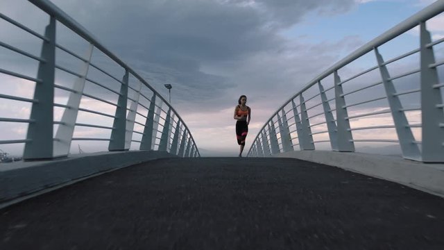 fit young woman running athlete sprinting fast running intense workout challenge training endurance in urban city