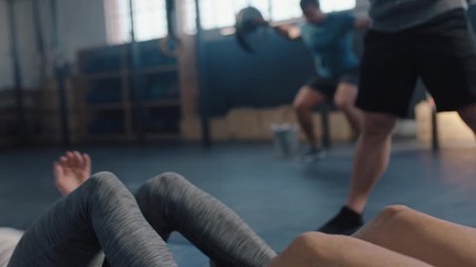 fitness athletes training sit ups exercise friends enjoying intense workout together doing cardio practice in gym bodybuilding cross fit challenge
