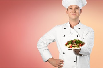 Young handsome chef showing his dish