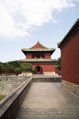 Fototapeta premium Bell Tower in the Temple of Heaven Park with trees and clouds - Beijing, China