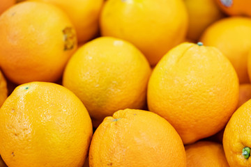 Oranges are fruit that has rich in vitamins and an acid taste. They are displaying on stall to sell to somebody, and looks very fresh.
