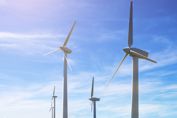 modern wind power generators against the blue sky, toned