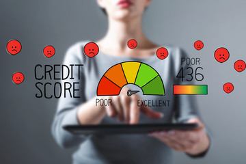 Poor credit score with business woman using a tablet computer