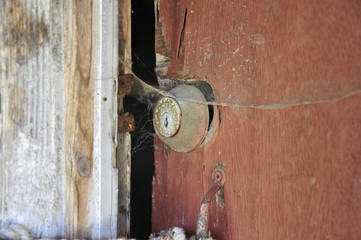 An old lock on a decrepit house