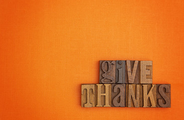 Autumn Background with the Words Saying Give Thanks in Block Letters