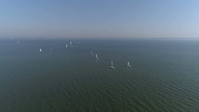 Aerial top view of a sailing yacht regatta. Flying over boats. 4k video 