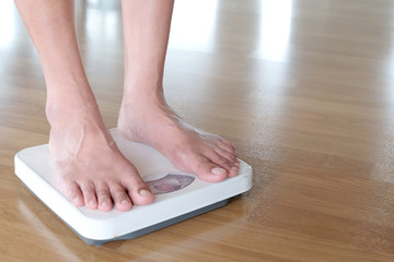 Legs of men standing on scales weight. Concept of health and weight loss.