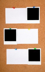 Blank photographs on a bulletin board with blank index cards