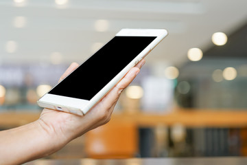 smartphone in one hand  on blurred background with clipping path on screen