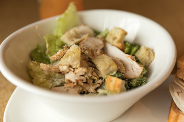 Chicken Caesar salad taken in natural light