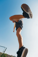 Sportive man make parkour tricks while jumping