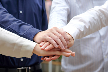 Four hand of people assemble corporate meeting show symbol teamwork quality on bokeh nature background