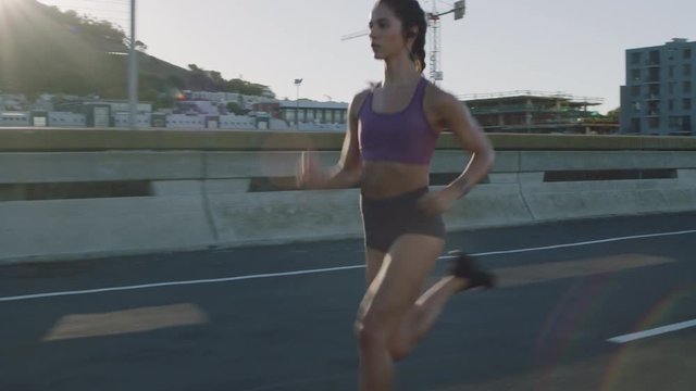 fit young woman running in city at sunrise training cardio workout female runner athlete enjoying intense fitness lifestyle