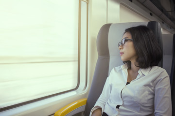 Beautiful woman daydreaming in airport train